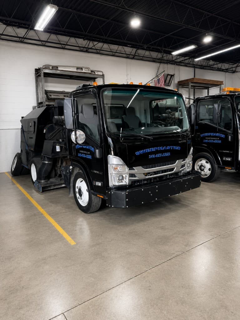 Front view of a Sweepmaster vacuum sweeper truck